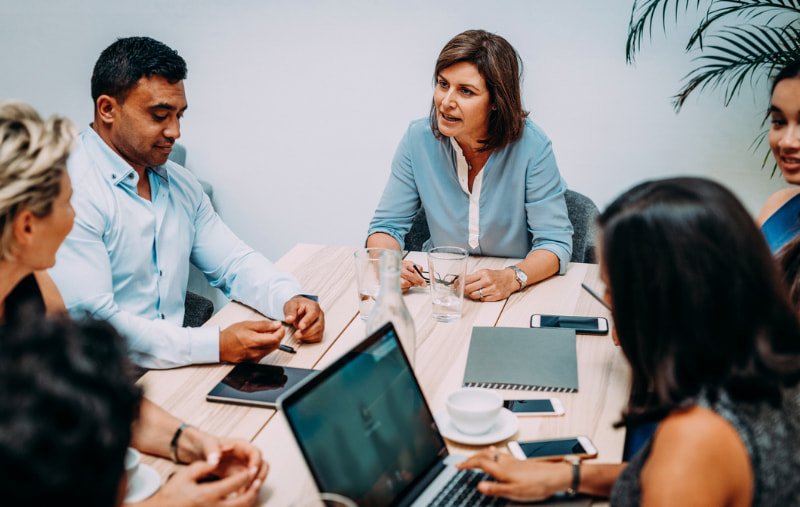 Group of business people sitting at the table and discussing