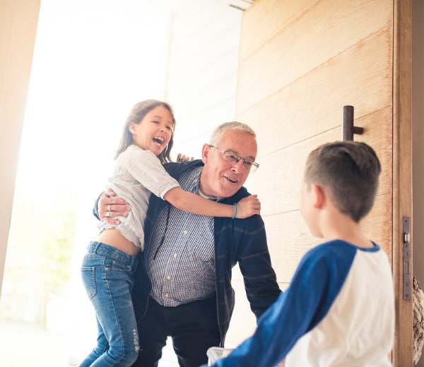 Children running towards their grandfathe