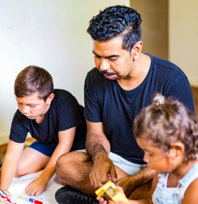 Father teaching his son and daughter