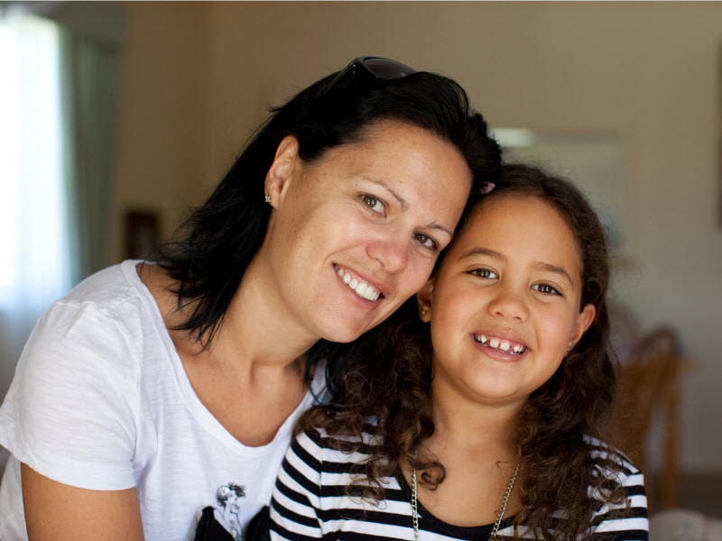 Mother and daughter smiling at the camera