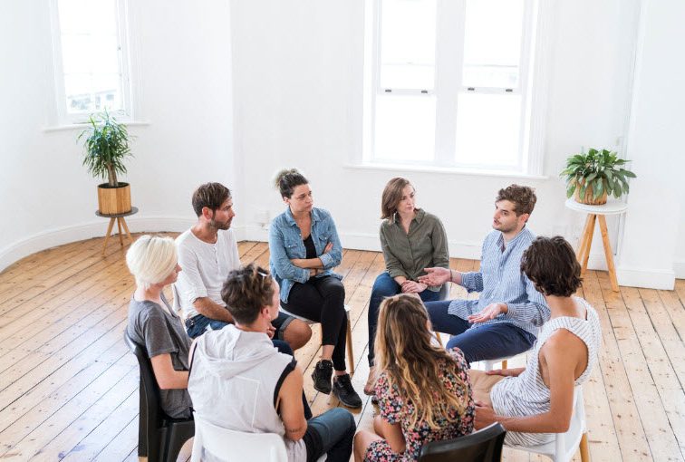 Man talking in a group counselling session