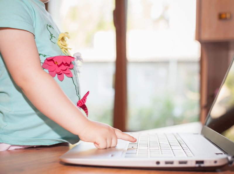 Child using laptop at home