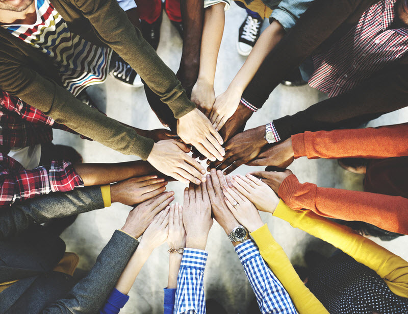 Group of different nationalities putting their hands together