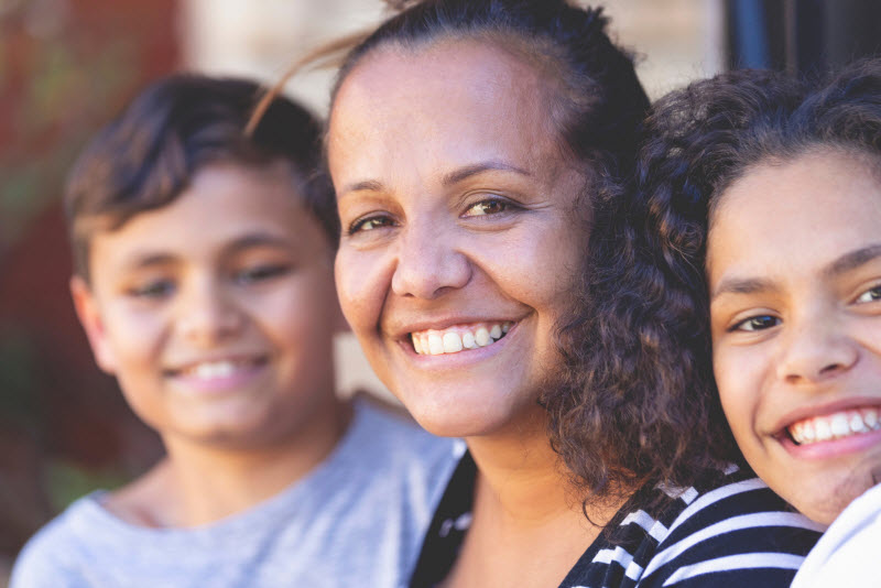 Mother smiling at the camera with her kids